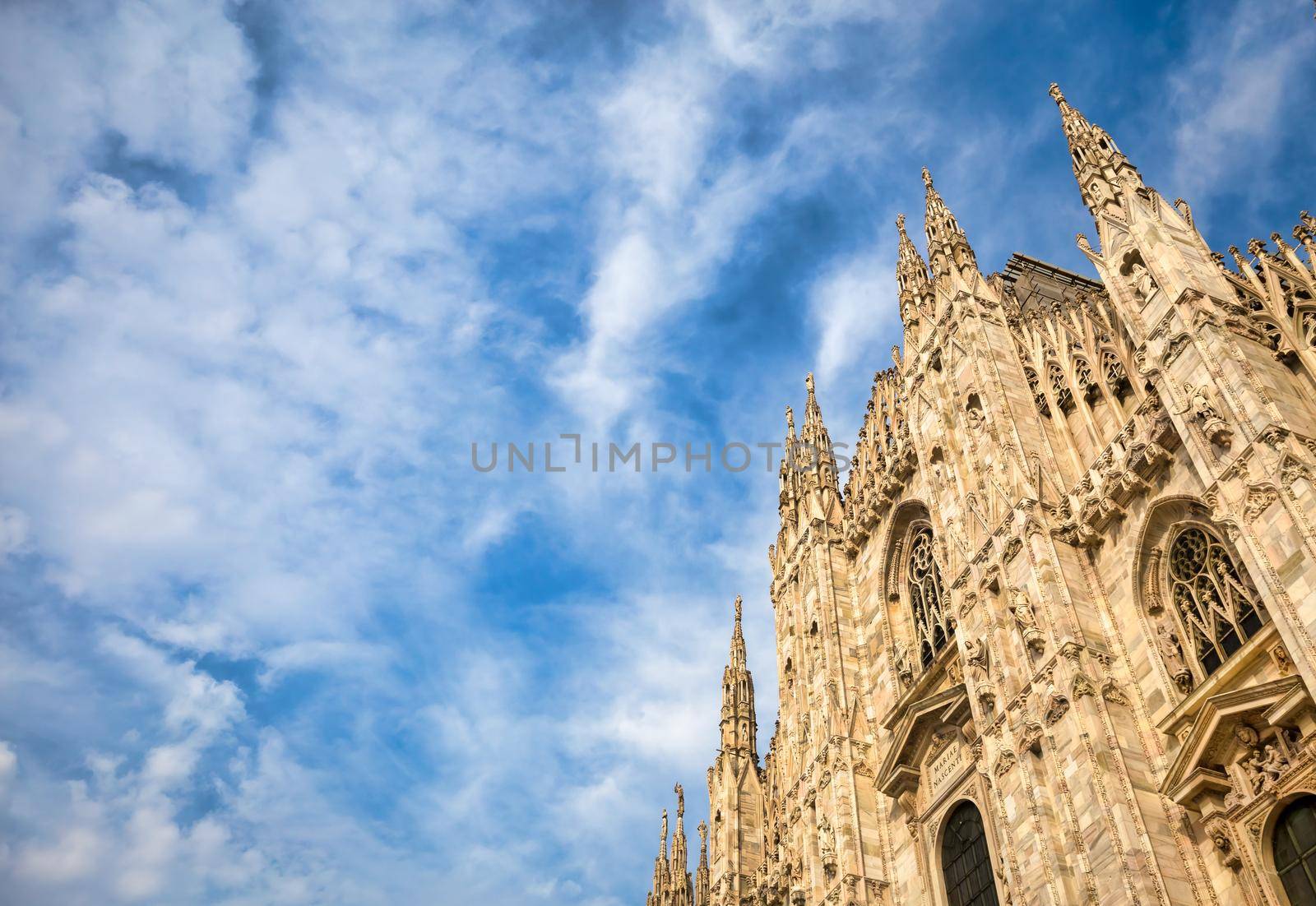 Milan Cathedral (Duomo di Milano) with blue sky and sunset light by Perseomedusa