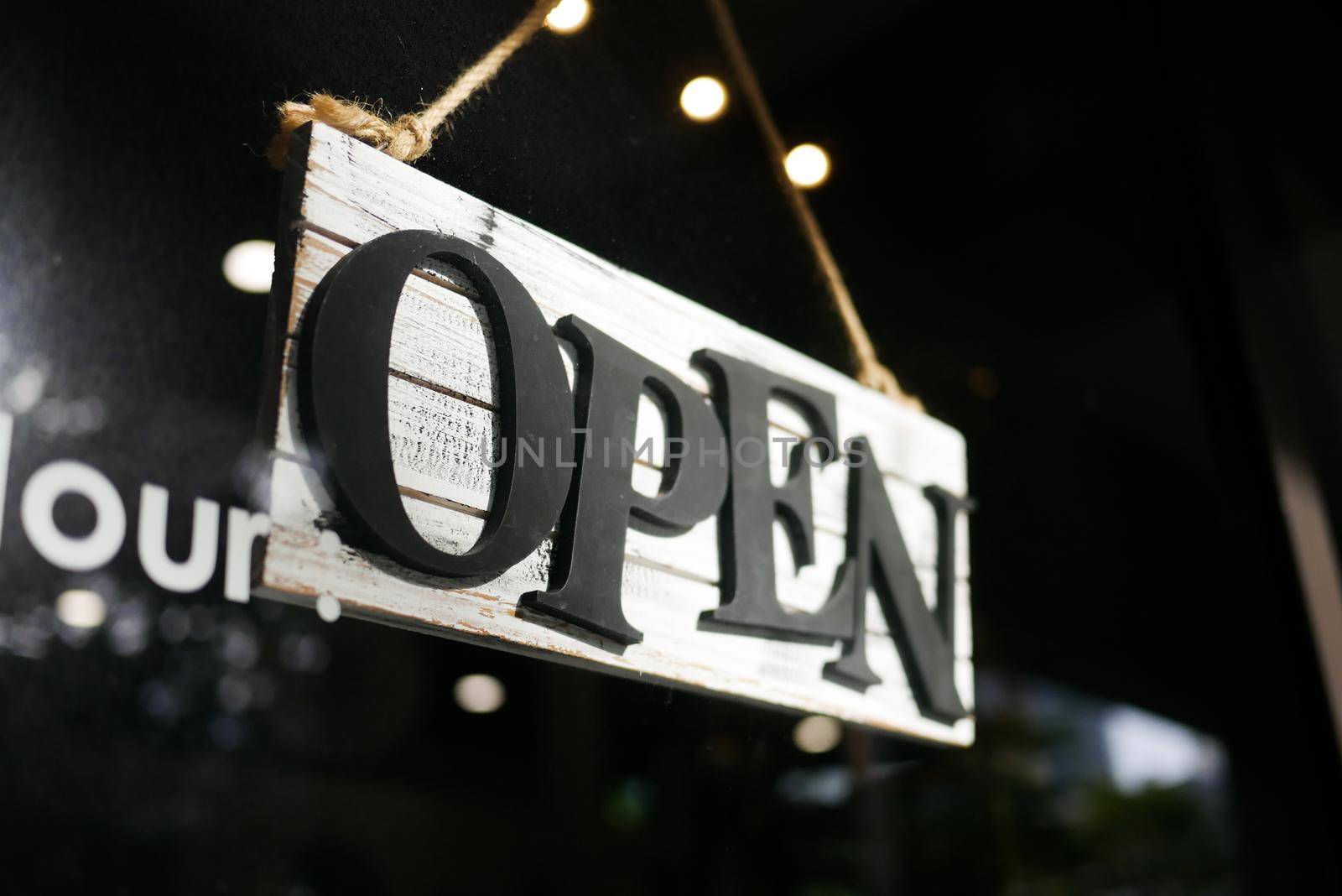 Open sign hanging front of cafe