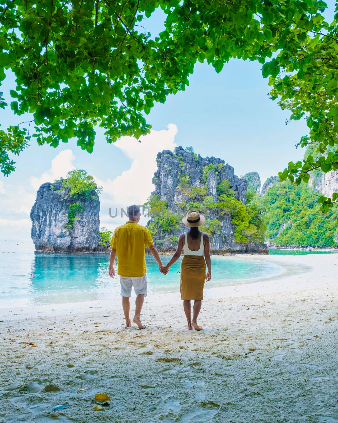 Koh Hong Island Krabi Thailand, a couple of men and women on the beach of Koh Hong, a tropical white beach with Asian women and European men in Krabi Thailand