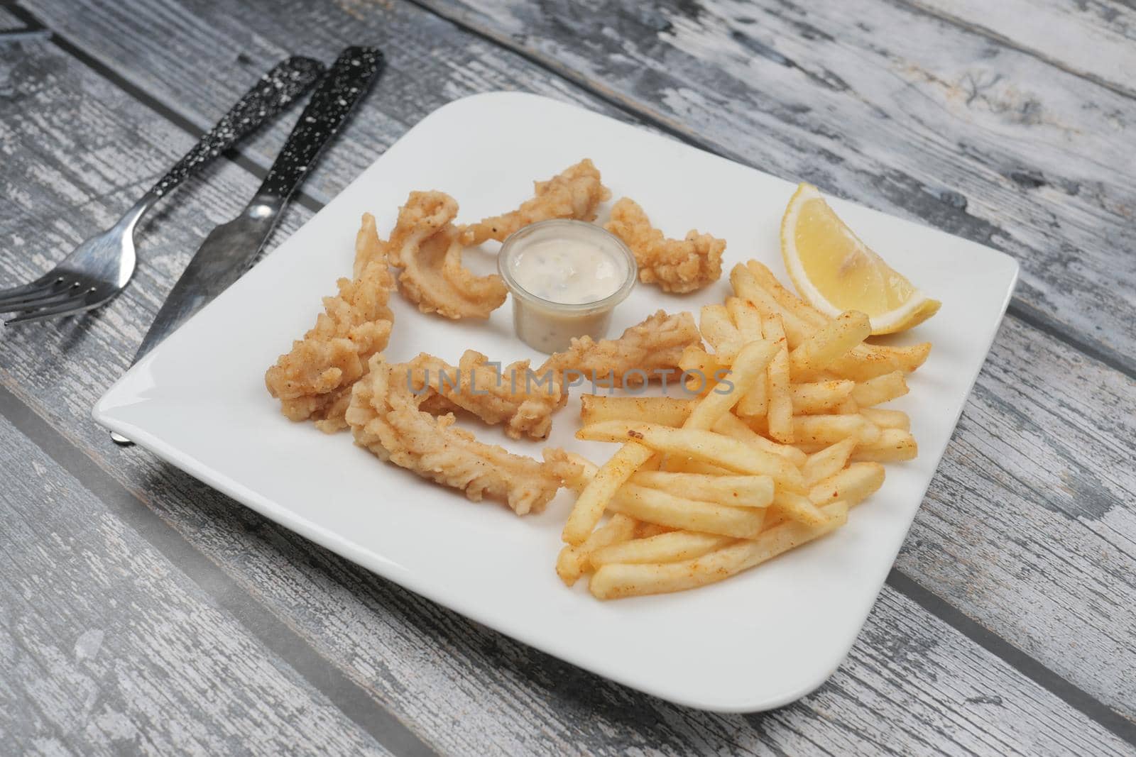 Crunchy Deep fried squid stick and french fries on table ,