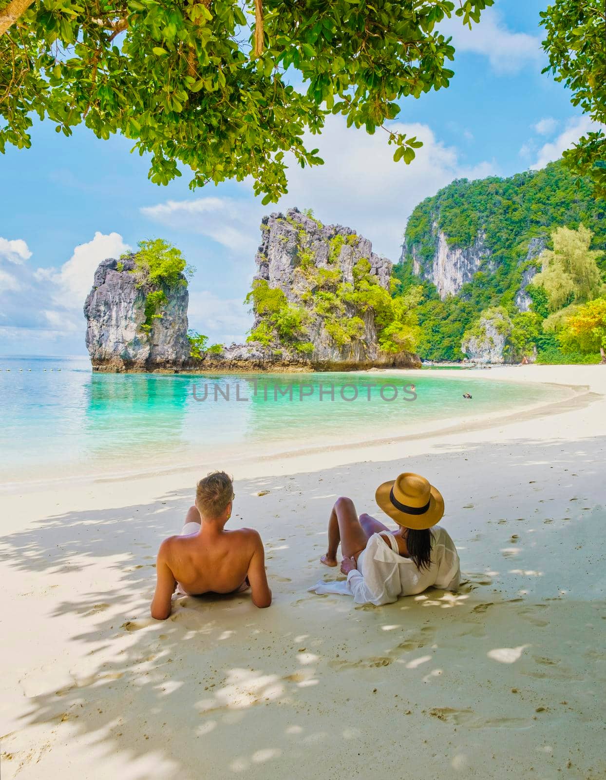 Koh Hong Island Krabi Thailand, a couple of men and women on the beach of Koh Hong, a tropical white beach with Asian women and European men in Krabi Thailand