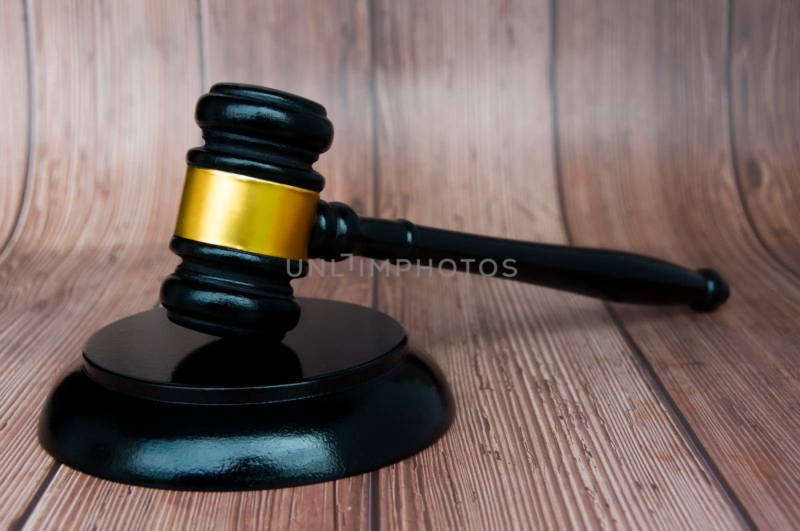 Judge gavel on wooden desk background with space customizable for text or ideas. Copy space and law concept