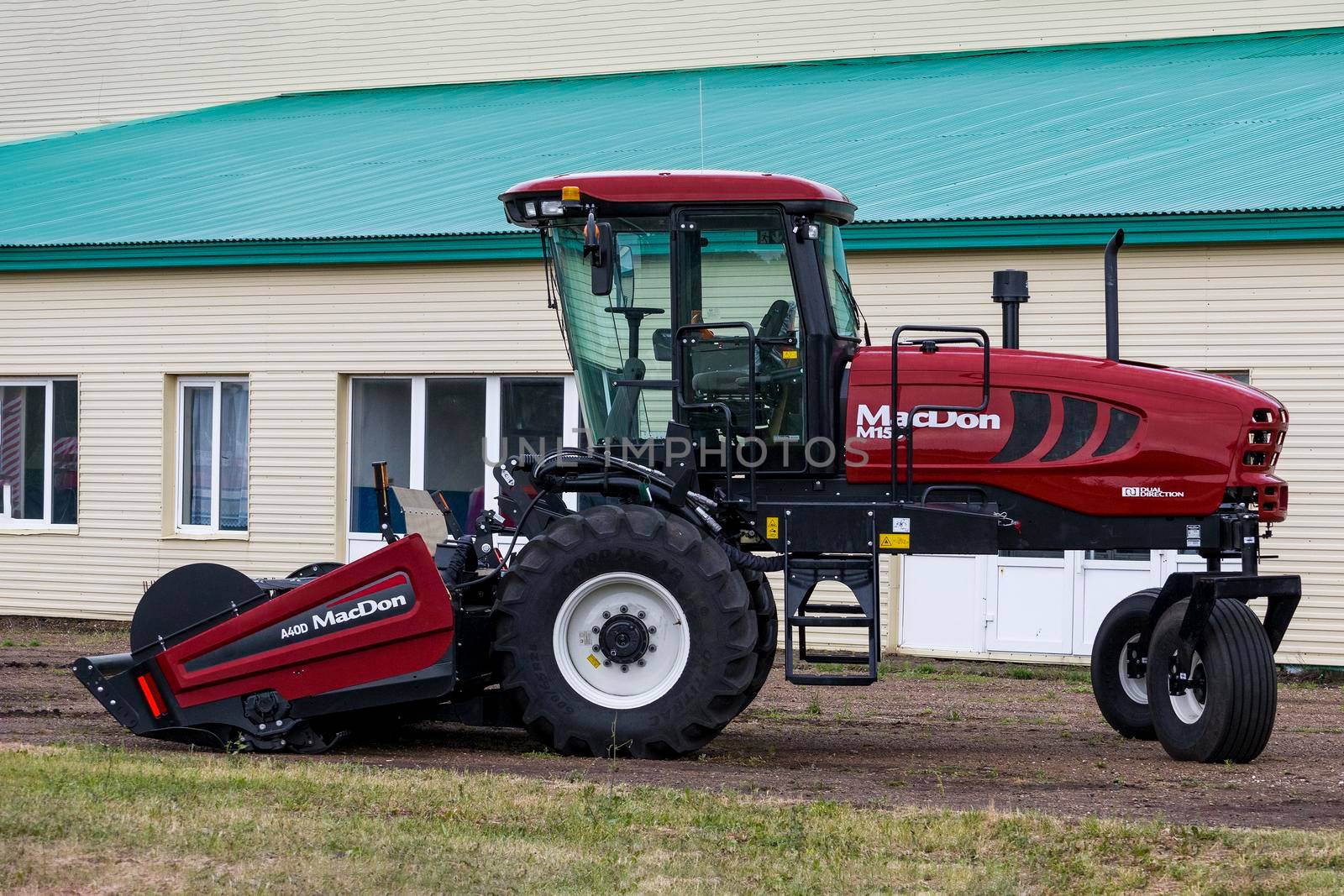 Powerful red harvester brand MacDon, Bashkortostan, Russia - 19 June, 2022. by Essffes