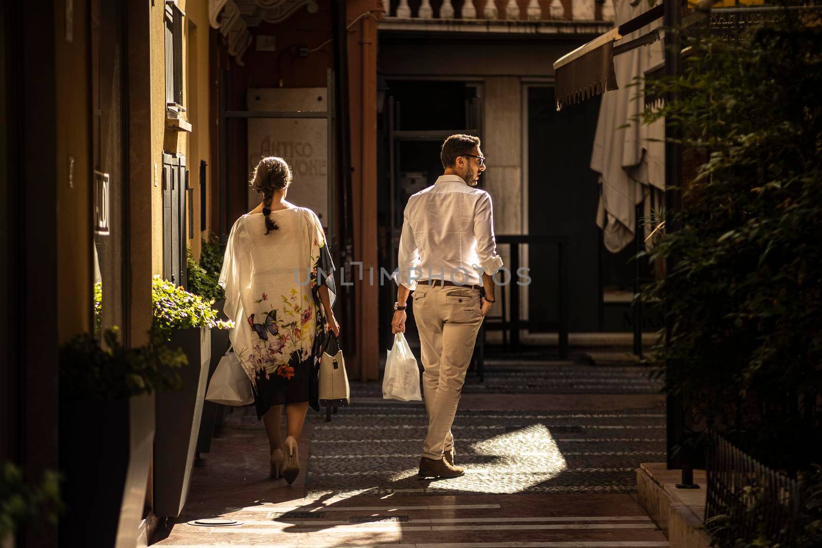 Rovigo, Italy 29 july 2022: Couple goes shopping in Italian historic city boutiques
