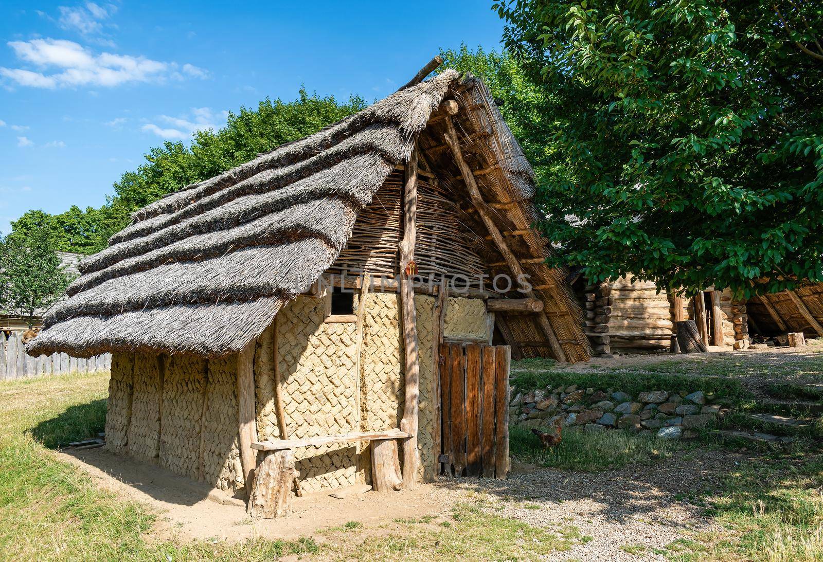 Great Moravian Museum Blue Czech Republic. Mud brick huts, thatched roof and gable braided from wicker
