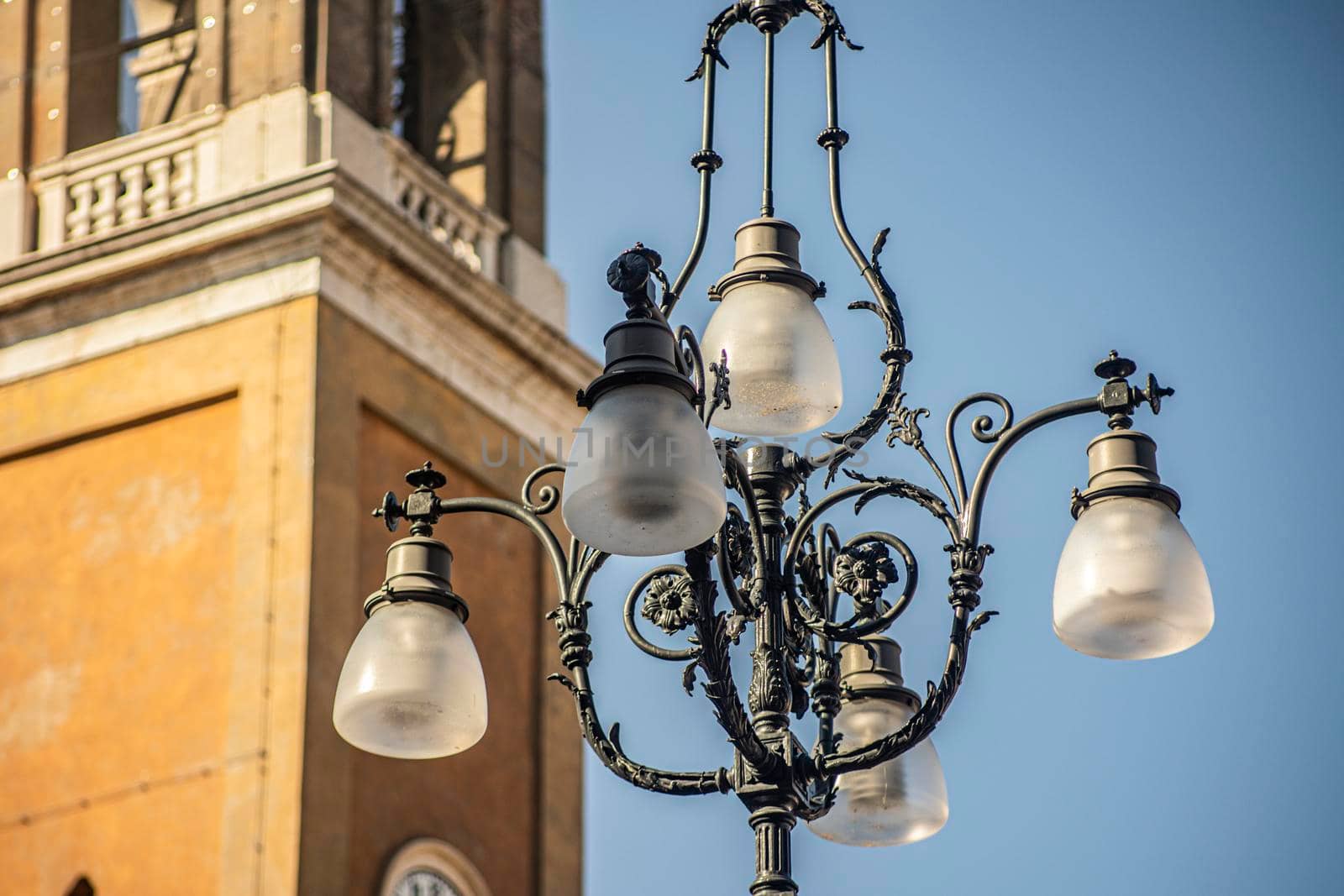 Ancient street lamp in historic city by pippocarlot