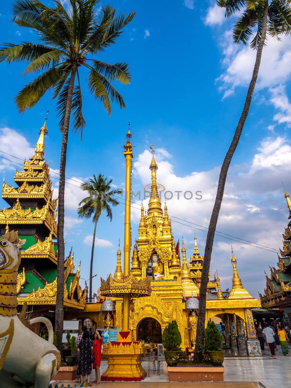 Group of golden pagoda and square hall mondop and golden tiered umbrella under the blue sky by Satakorn