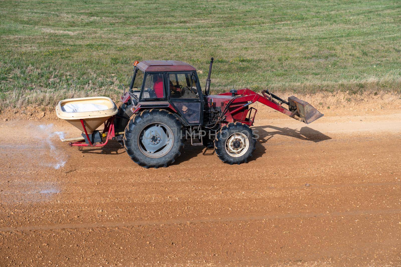 the tractor treats the chemistry of the autocross tracks before the races.
