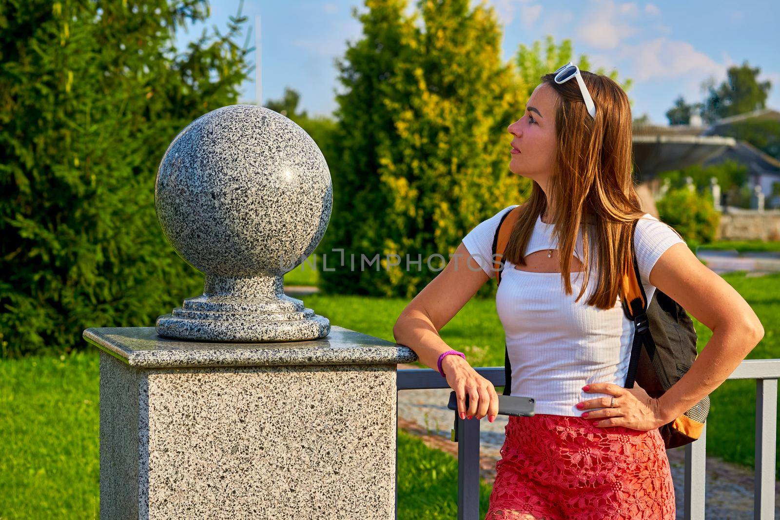 Young woman tourist sightseeing on a warm summer day.Granite ball. by jovani68
