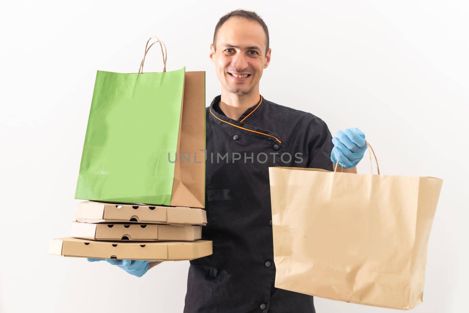 Food delivery in the restaurant. The chef packs food by Andelov13