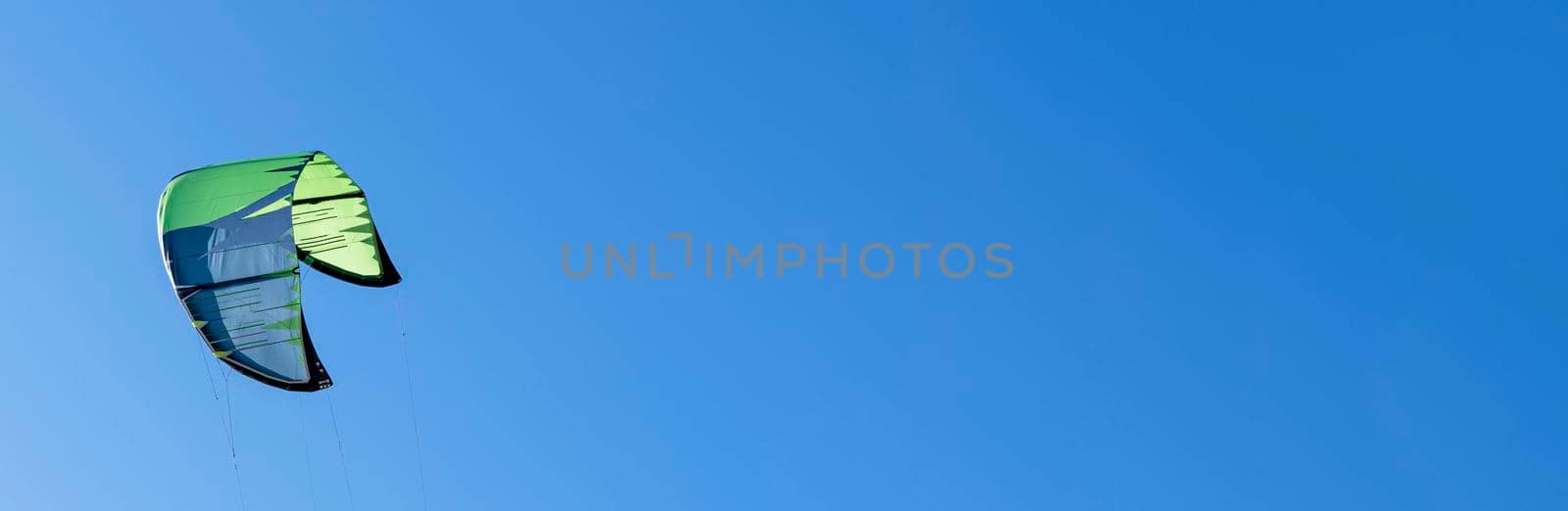 wing of kitesurfing against the blue sky . Banner by audiznam2609