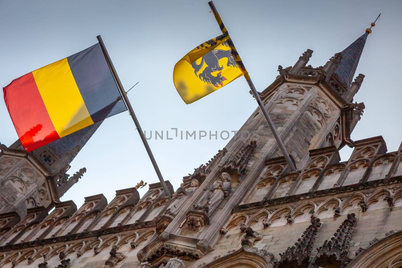 Belgian flags in Town hall, flemish architecture in Bruges at sunny day, Belgium