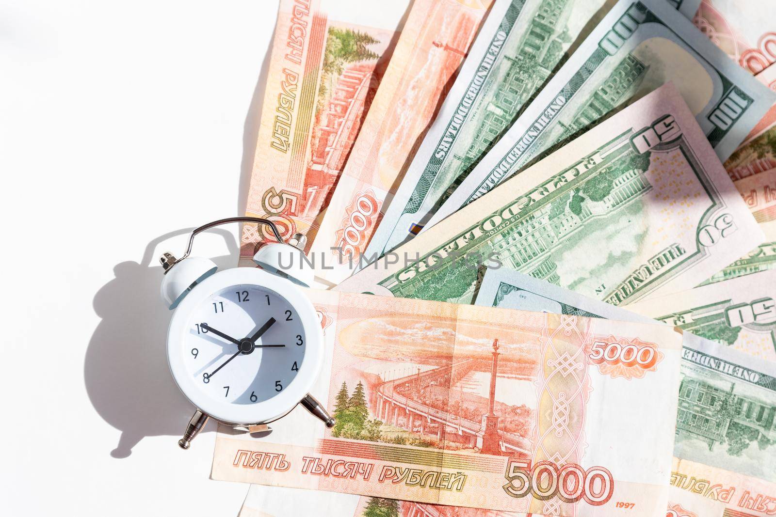 Time value of money concept, analog clock on US dollar banknote, depicting receiving money today can be poised to increase the future value by investing