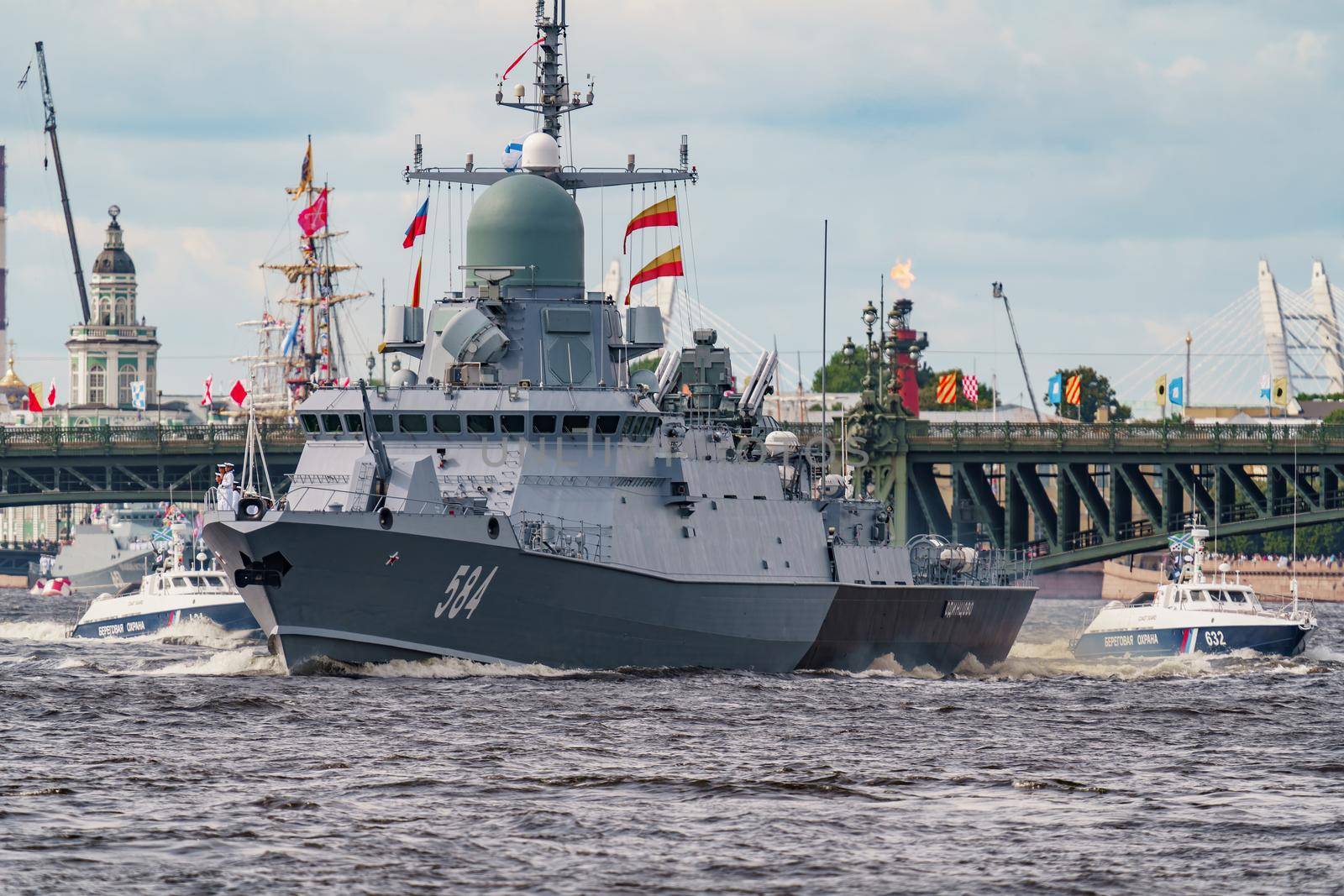 Russia, St. Petersburg, 28 July 2022: A lot of warships goes along the Neva River under open bridges at the time of the rehearsal of the celebration of the day of the Navy in sunny weather. High quality photo