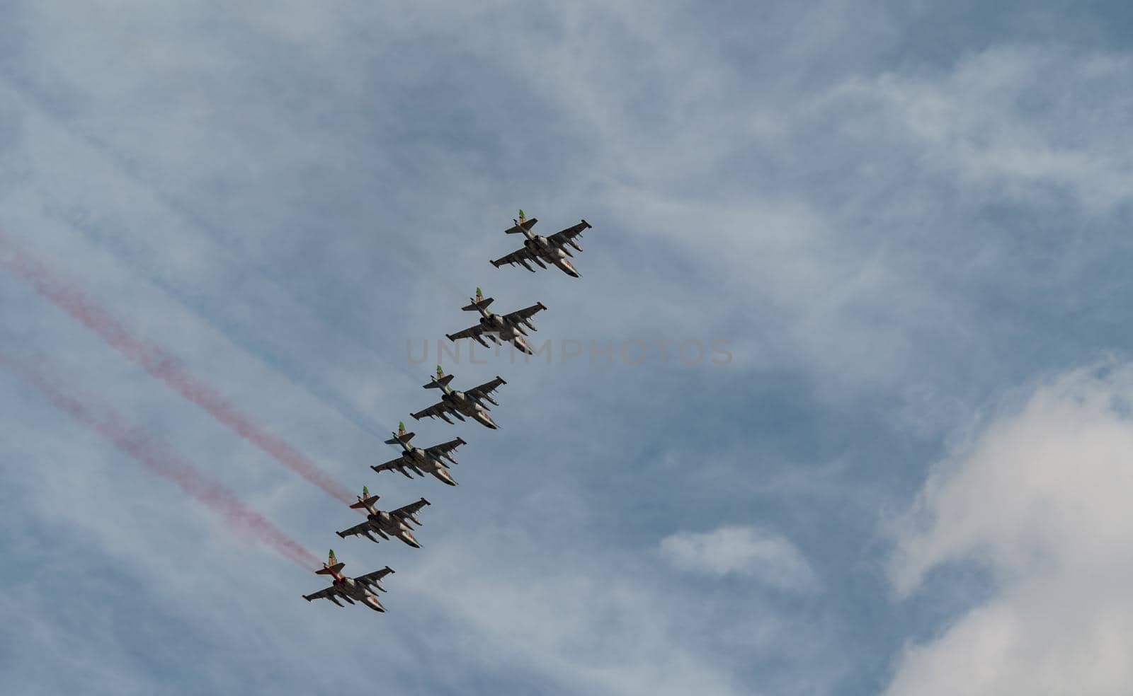 Russian Air Force planes paint the colors of the Russian flag in the sky on St. Petersburg during the celebration of the Day of the Navy. High quality photo