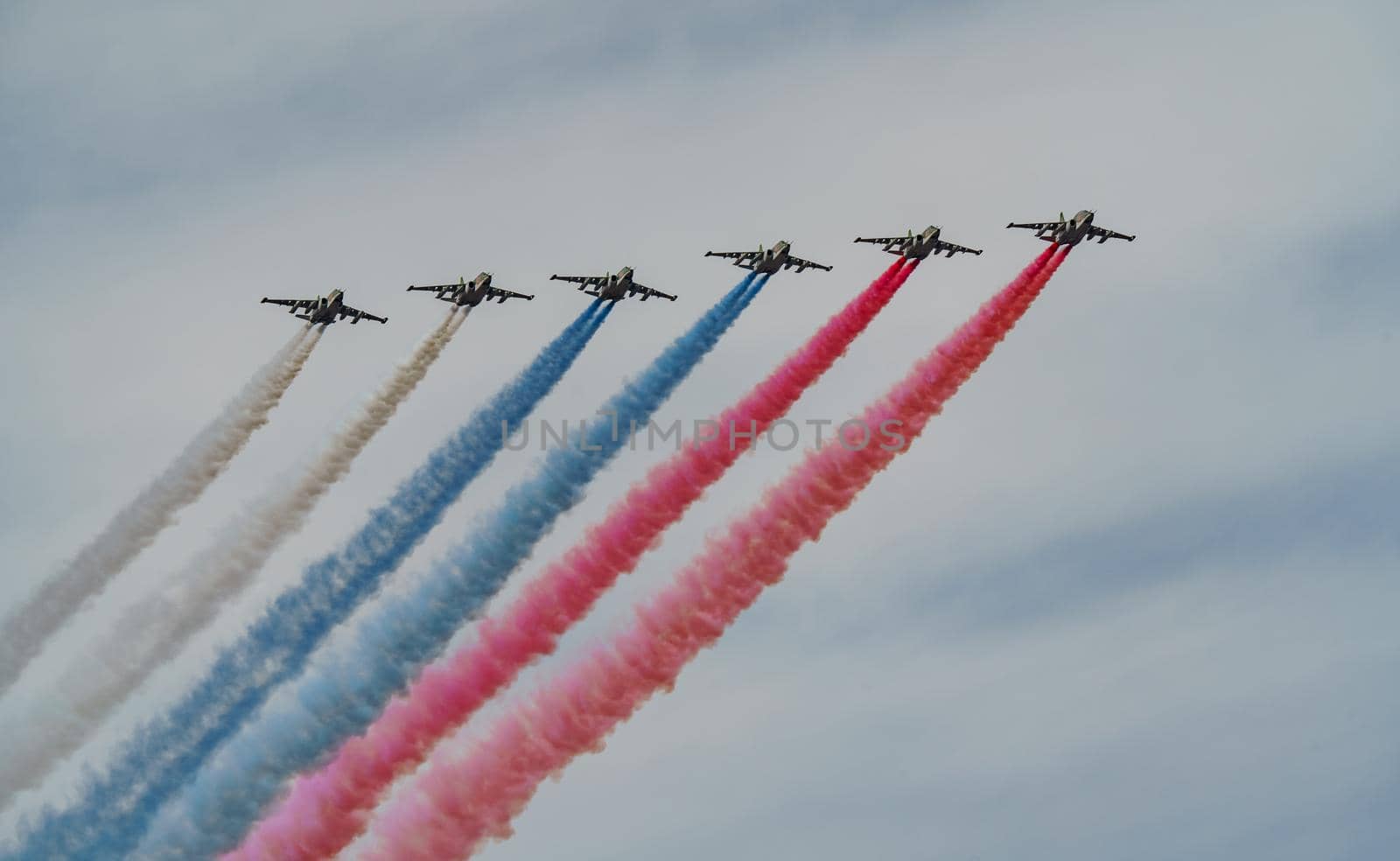 Russian Air Force planes paint the colors of the Russian flag in the sky on St. Petersburg during the celebration of the Day of the Navy. High quality photo