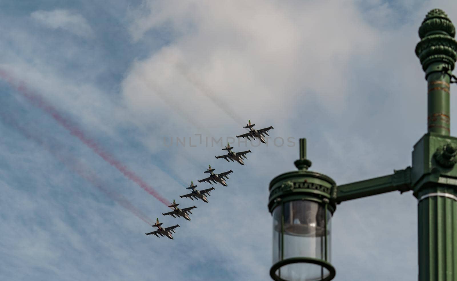 Russian Air Force planes paint the colors of the Russian flag in the sky on St. Petersburg during the celebration of the Day of the Navy. High quality photo