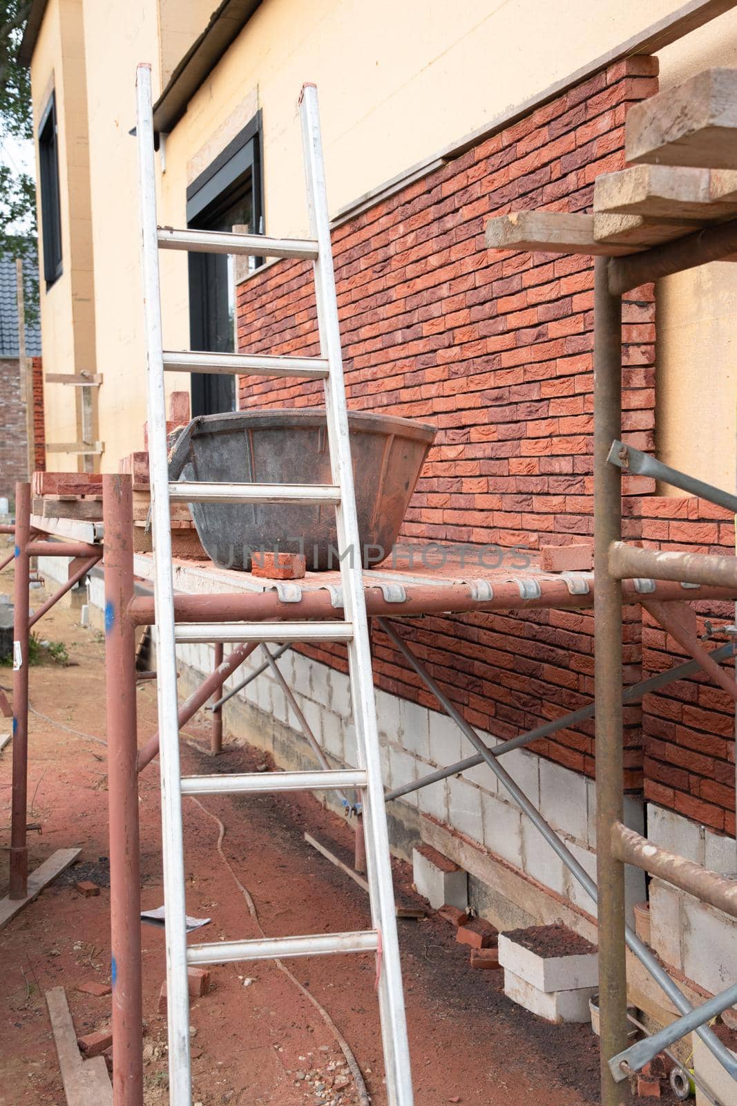 building a house supporting structure for laying bricks around a wooden base by KaterinaDalemans