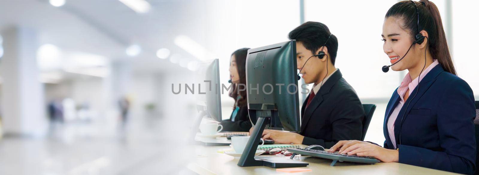 Business people wearing headset working in office in widen view to support remote customer or colleague. Call center, telemarketing, customer support agent provide service on telephone video call.