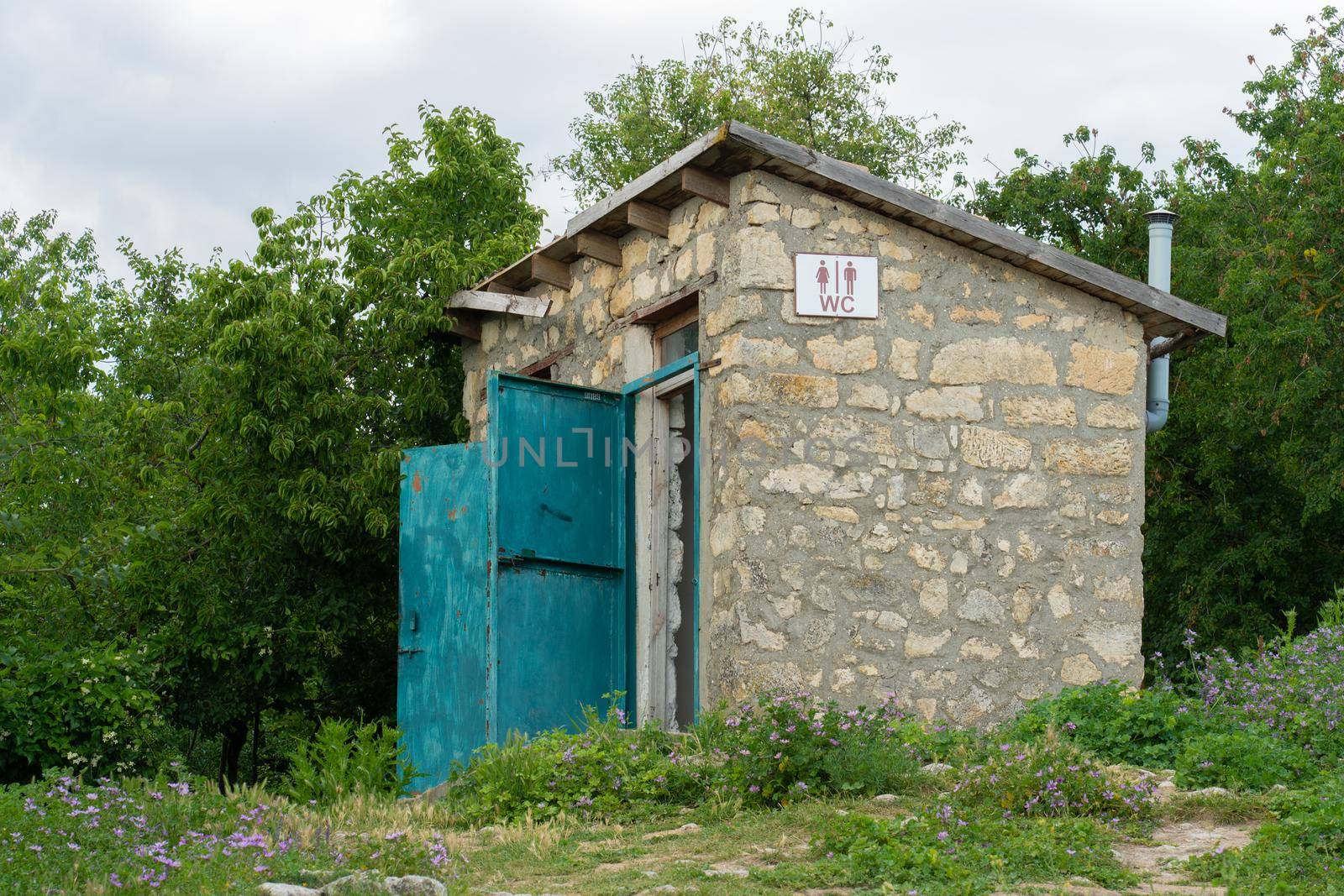 Sign stone old door toilet heart outdoor wood restroom outhouse, for retro design in building from wc facility, grass home. Love countryside ancient,