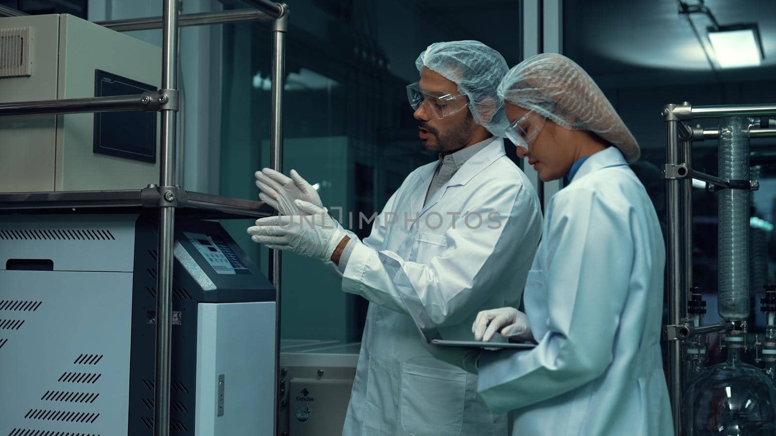Two scientist in professional uniform working in laboratory for chemical and biomedical experiment