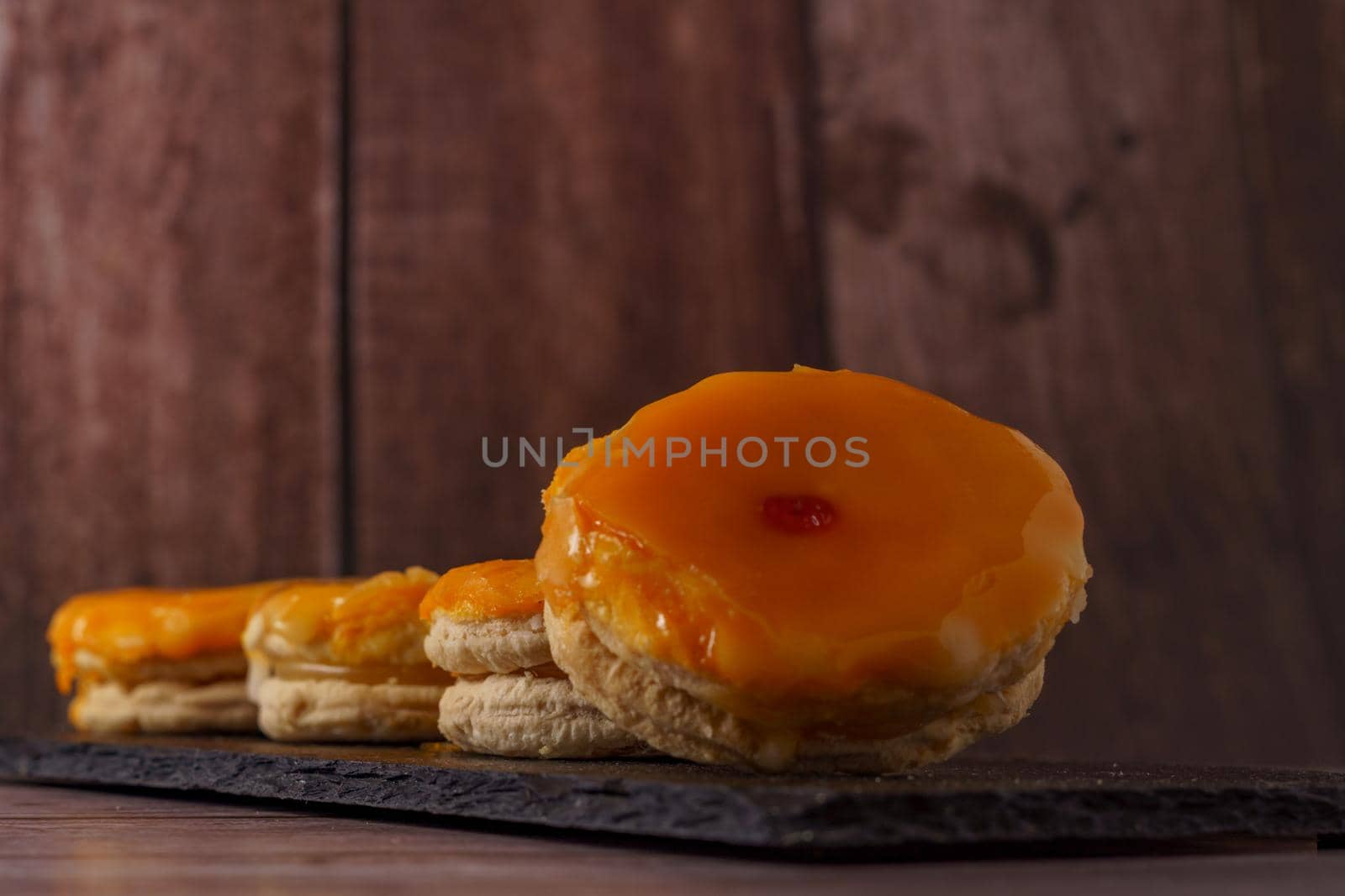 tortas locas or crazy cakes typical from andalucia, spain on a black tile on a wood background