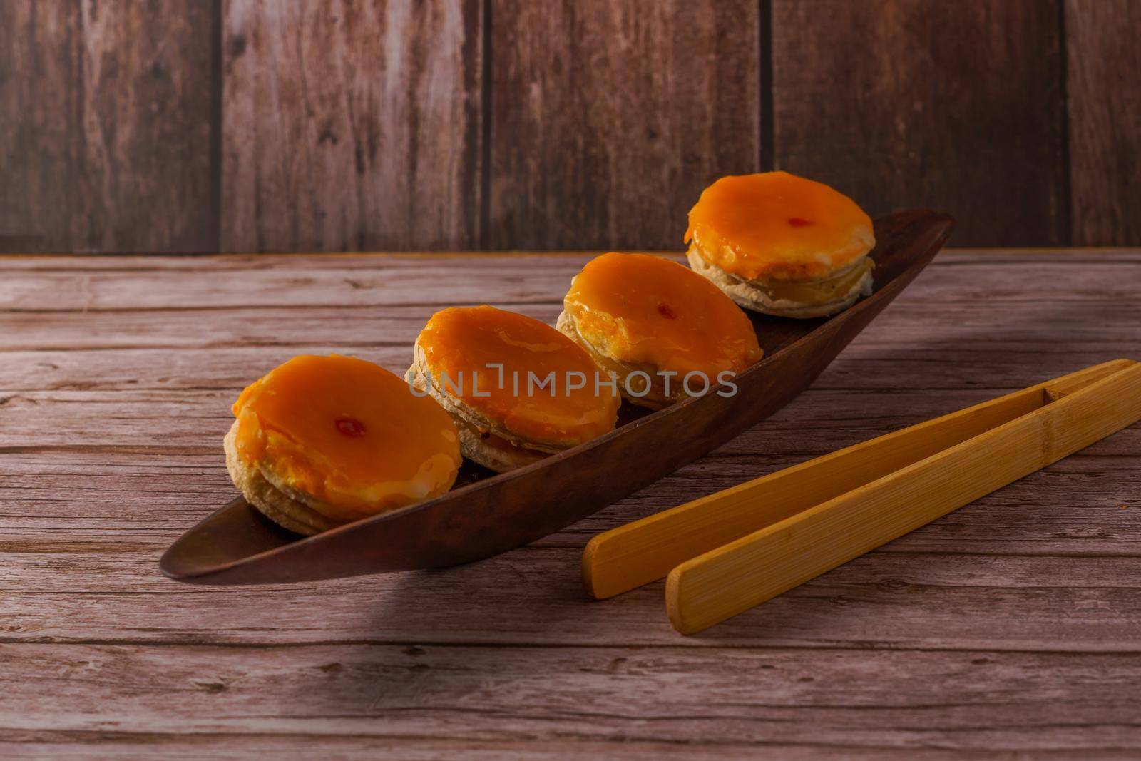 tortas locas or crazy cakes typical of andalucia, spain on a wooden bowl and some tongs