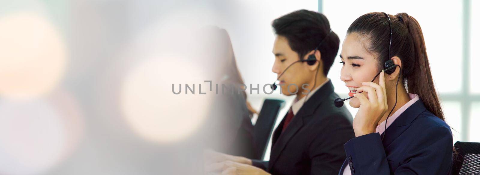 Business people wearing headset working in office in widen view to support remote customer or colleague. Call center, telemarketing, customer support agent provide service on telephone video call.