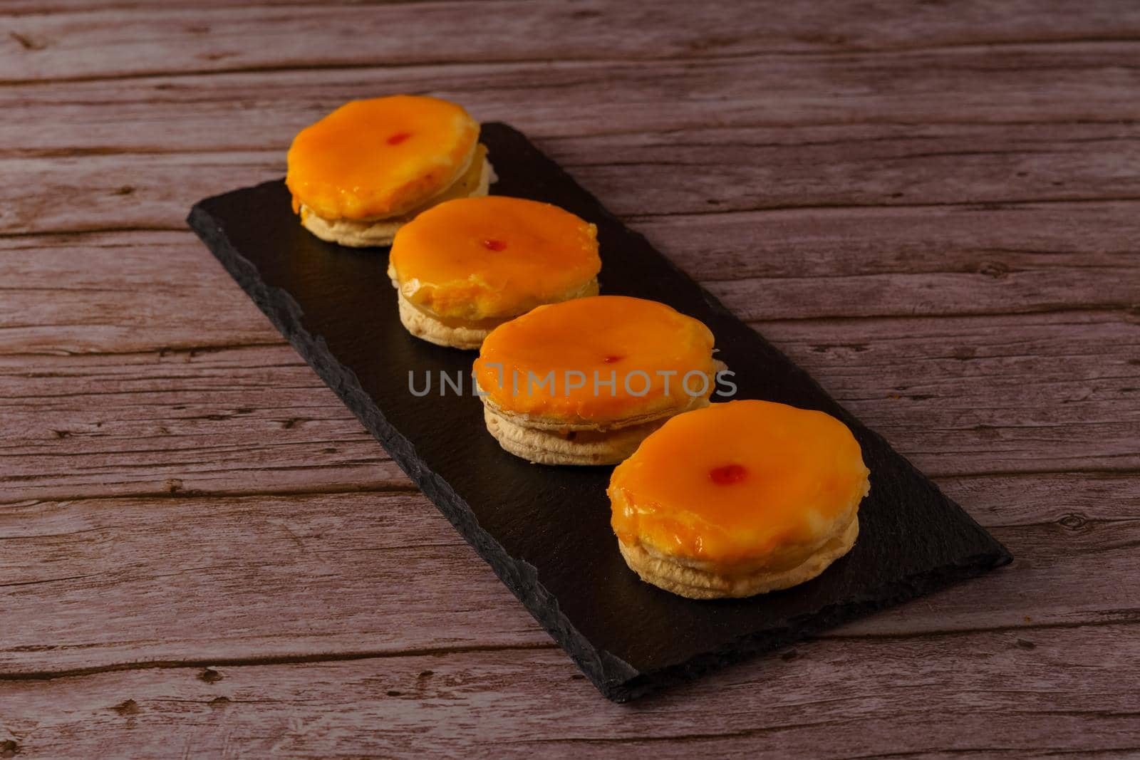 tortas locas or crazy cakes typical from andalucia, spain on a black tile on a wood background