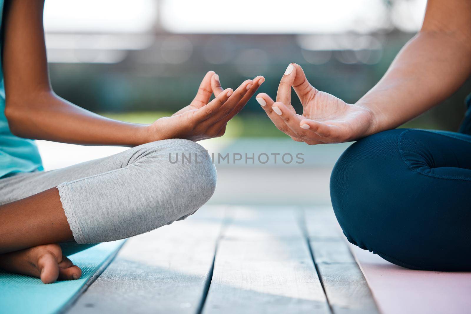 Finding peace from within. two unrecognizable people meditating at home