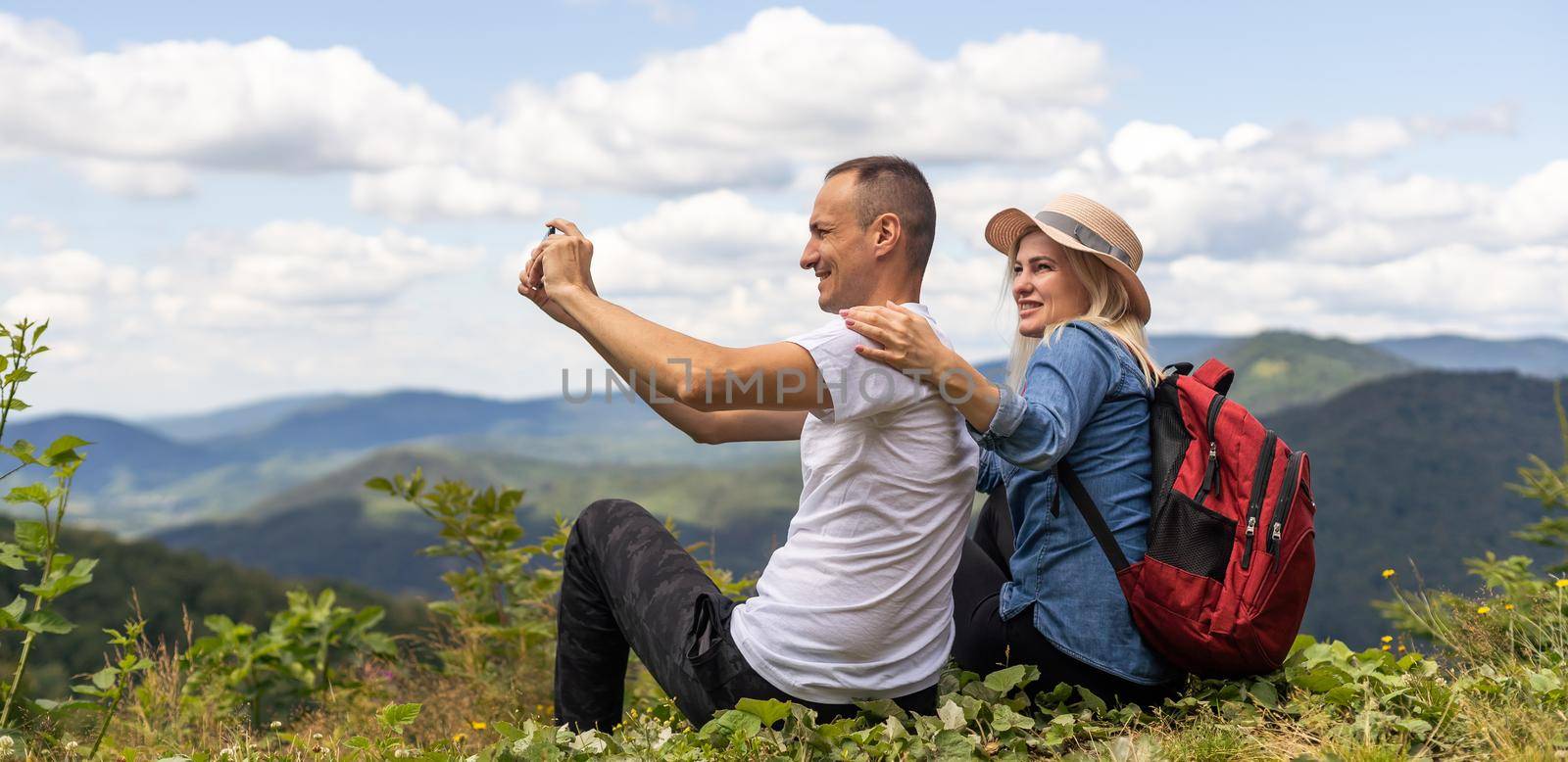 beautiful young couple enjoying nature at mountain.