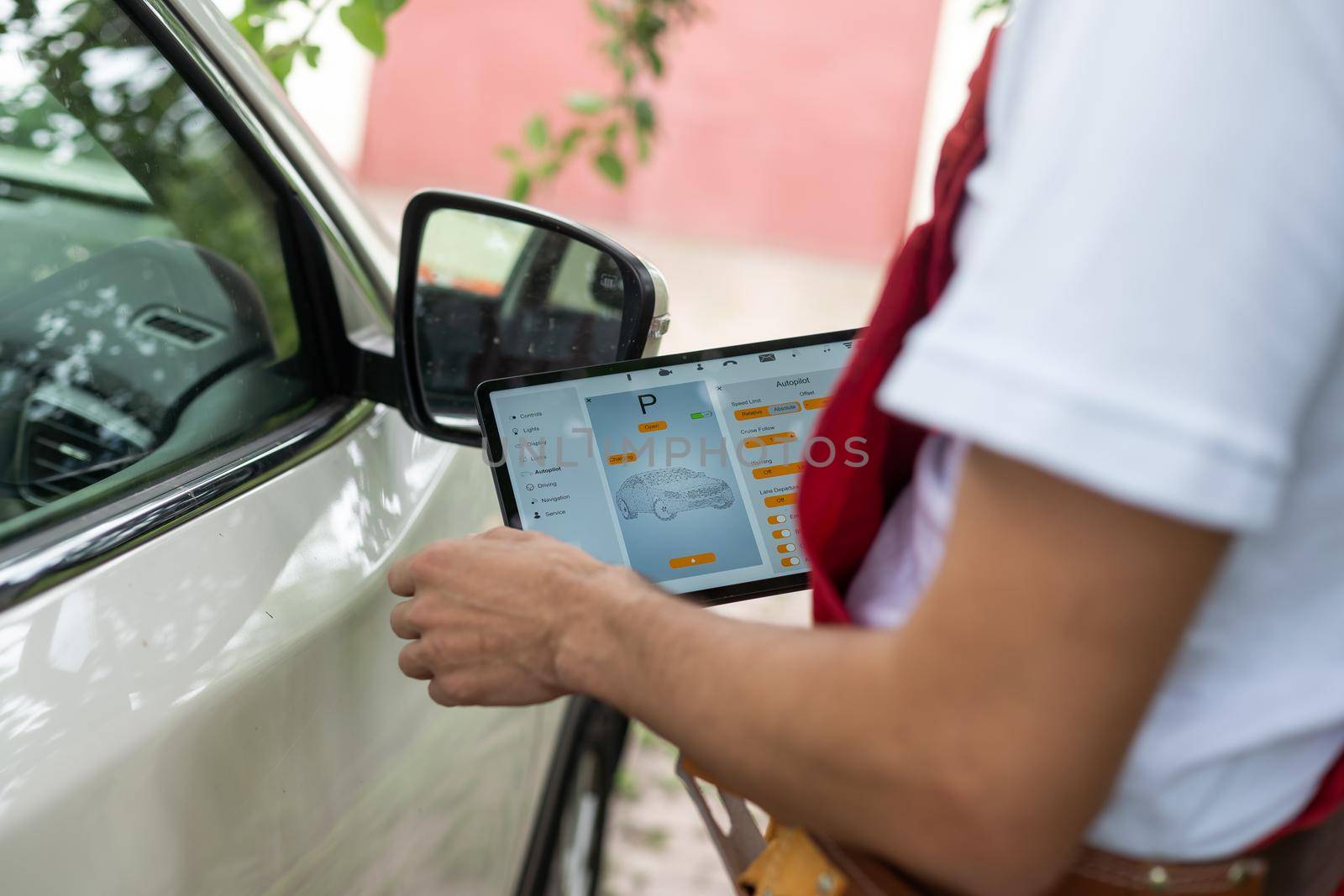 Close-up Of A Car Mechanic Using Digital Tablet.