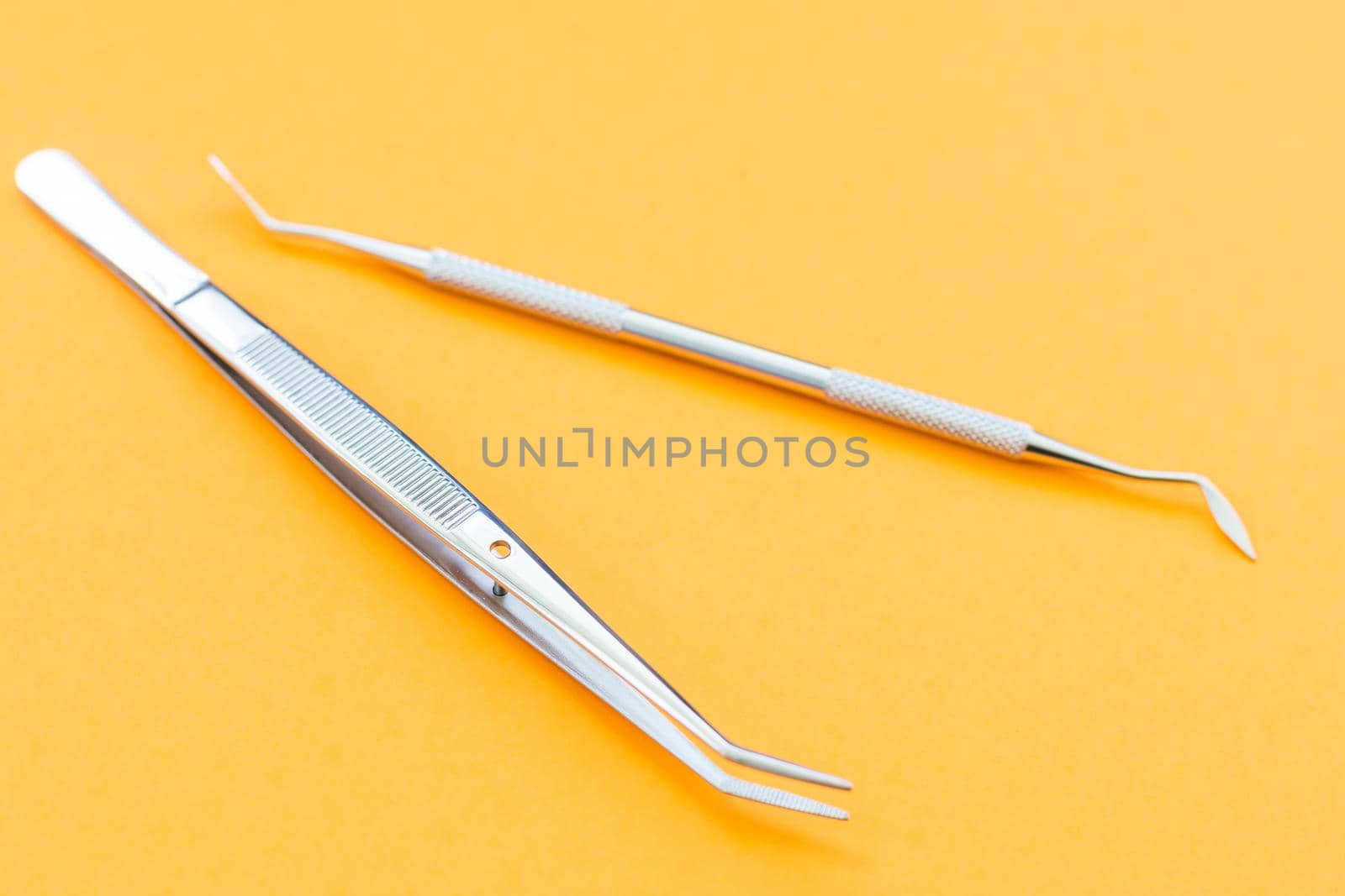 Dentist tools. Teethcare, dental health concept. orange background top view copy space by Andelov13
