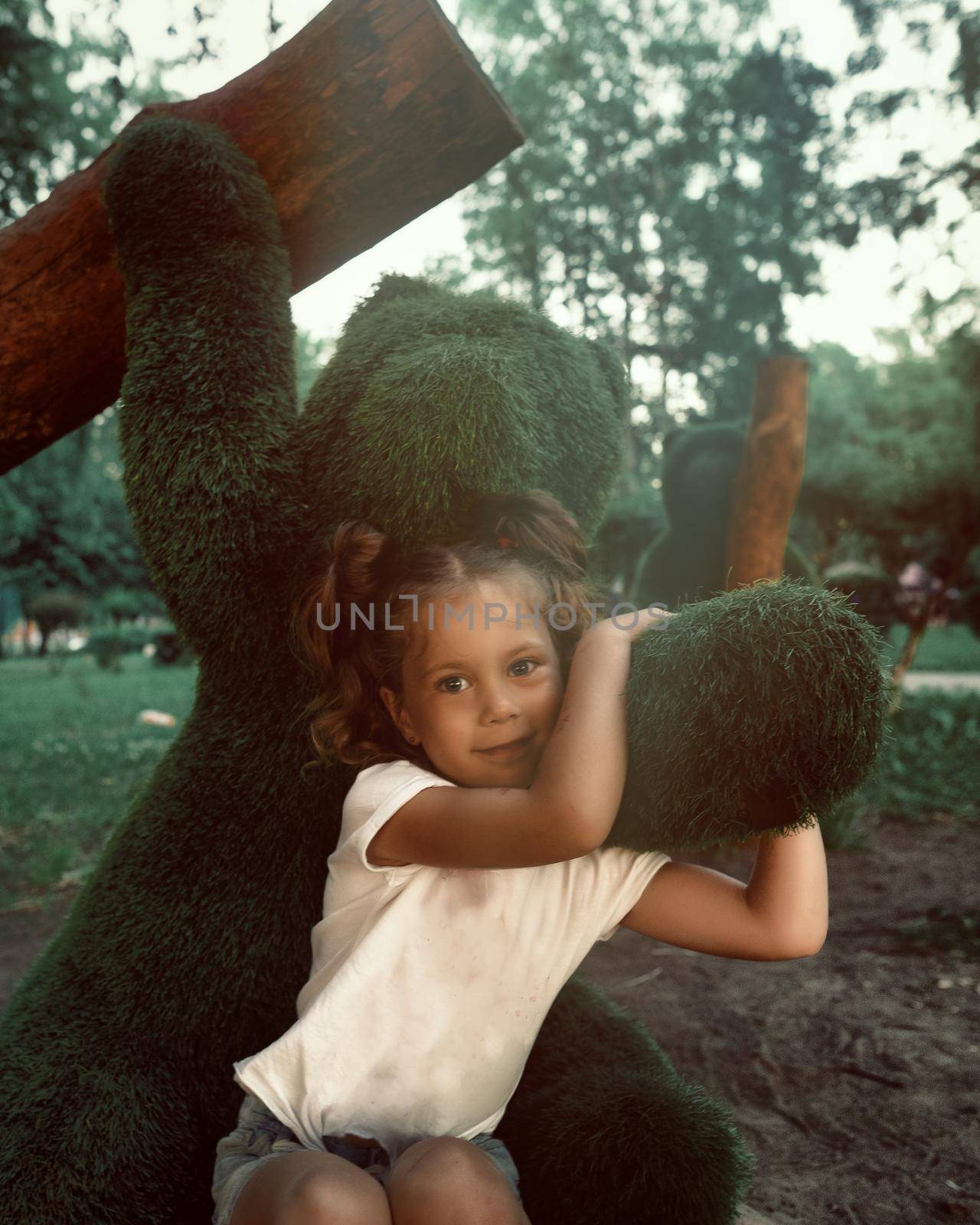 Portraits of a little girl on the playground with figures. High quality photo