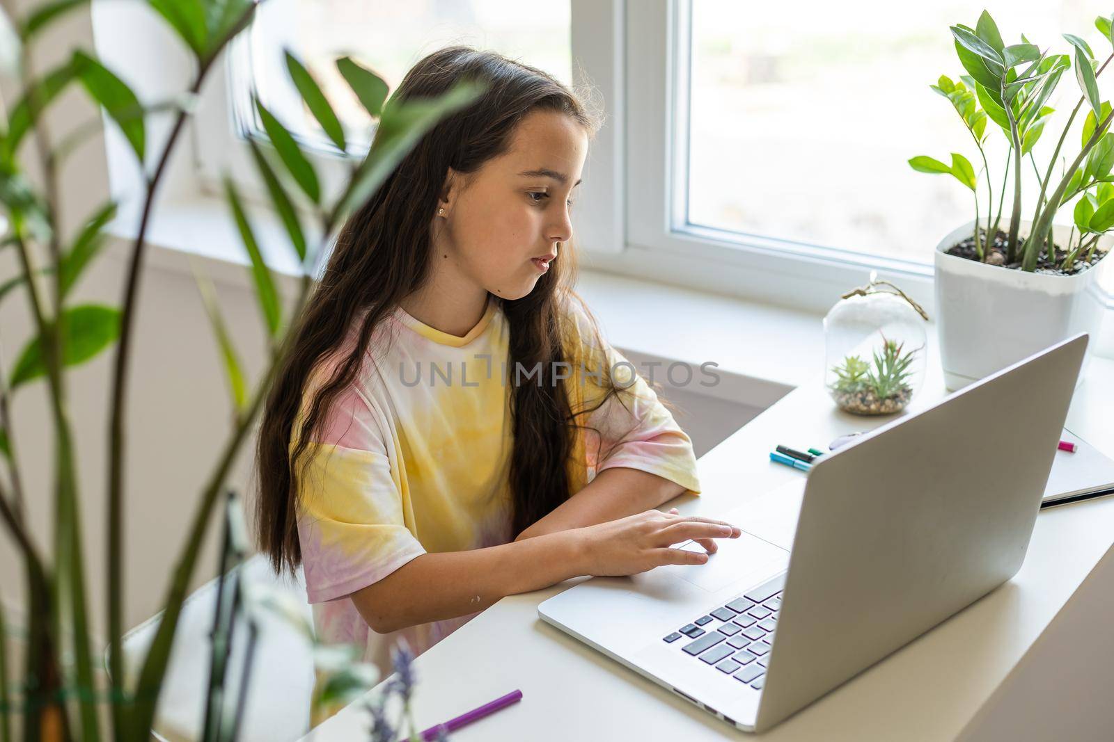 Excited Teen Girl Sitting In Living Room With Laptop, During Webinar At Home. Online School Tests Concept by Andelov13