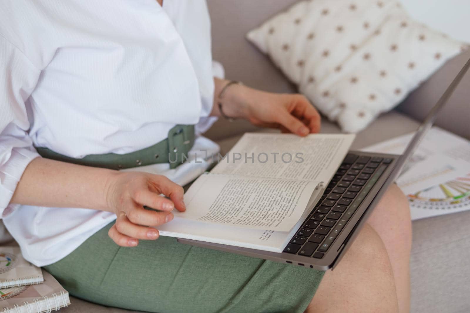 Tver, Russia-august 7, 2022. A woman with a laptop is studying human design. The concept of studying esoteric sciences. Studying rave postcards from human design.