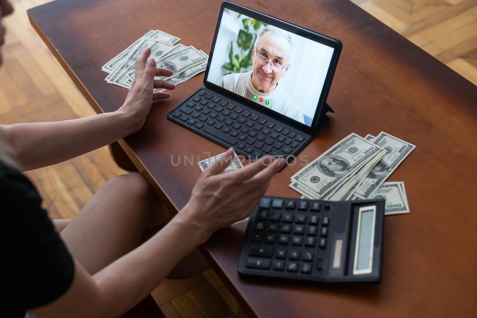 tablet screen and lot of hundred dollar bills. Business and social networking concept.
