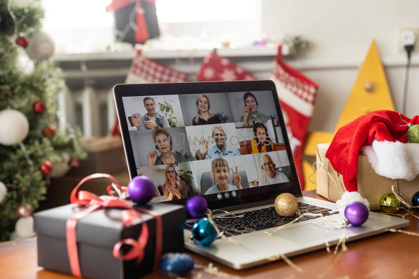 Virtual Christmas tree meeting team teleworking. Family video call remote conference. Laptop webcam screen view. Team meet working from their home offices. Happy hour party online woman team diversity