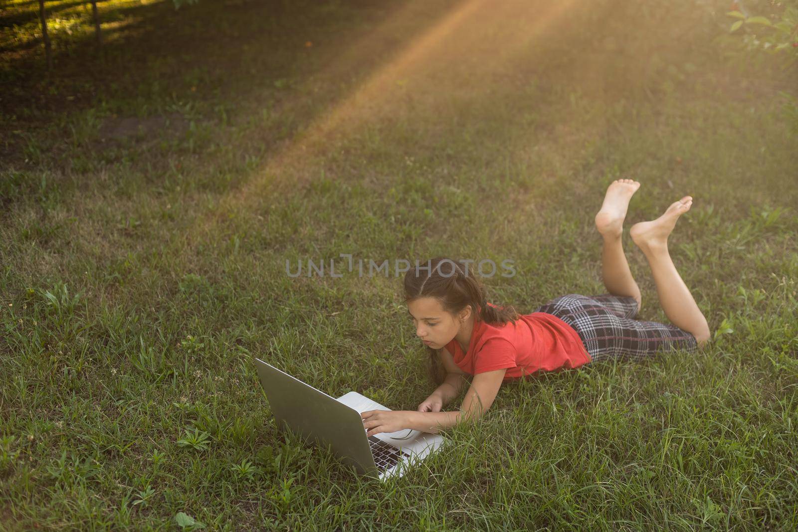 Kids using laptop learning in organic vegetable farmland in raral by Andelov13