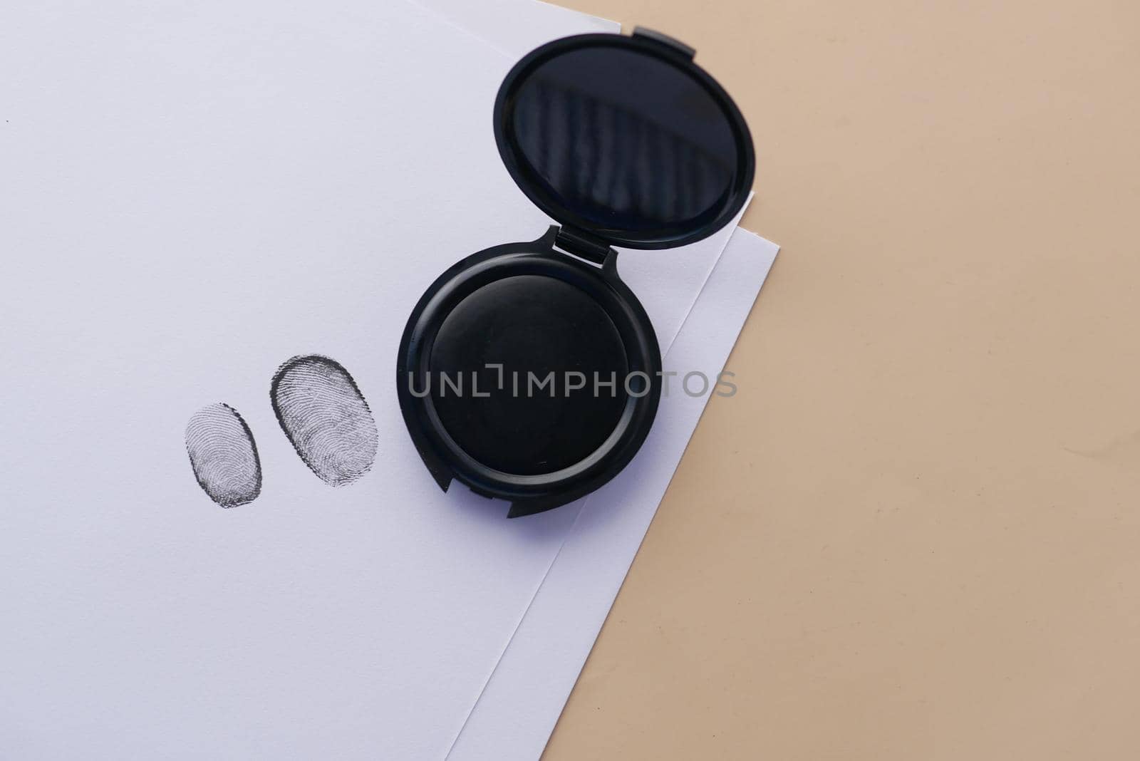 putting fingerprints on a paper close up
