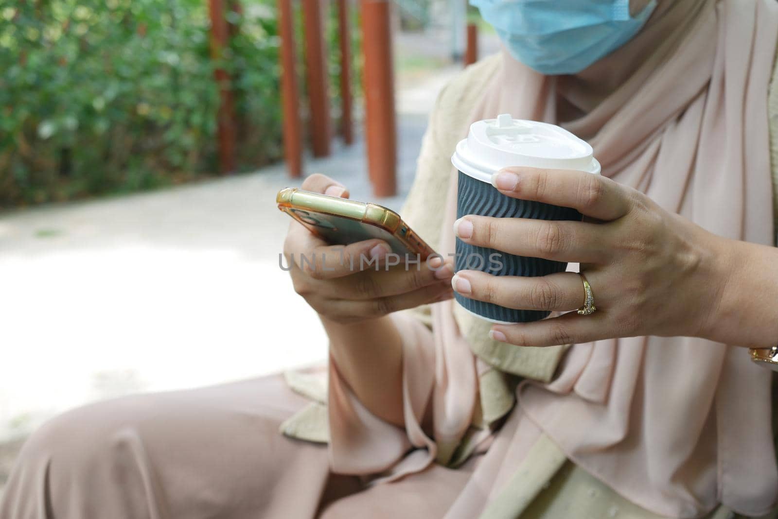 women hand holding smart phone and paper coffee cup ,