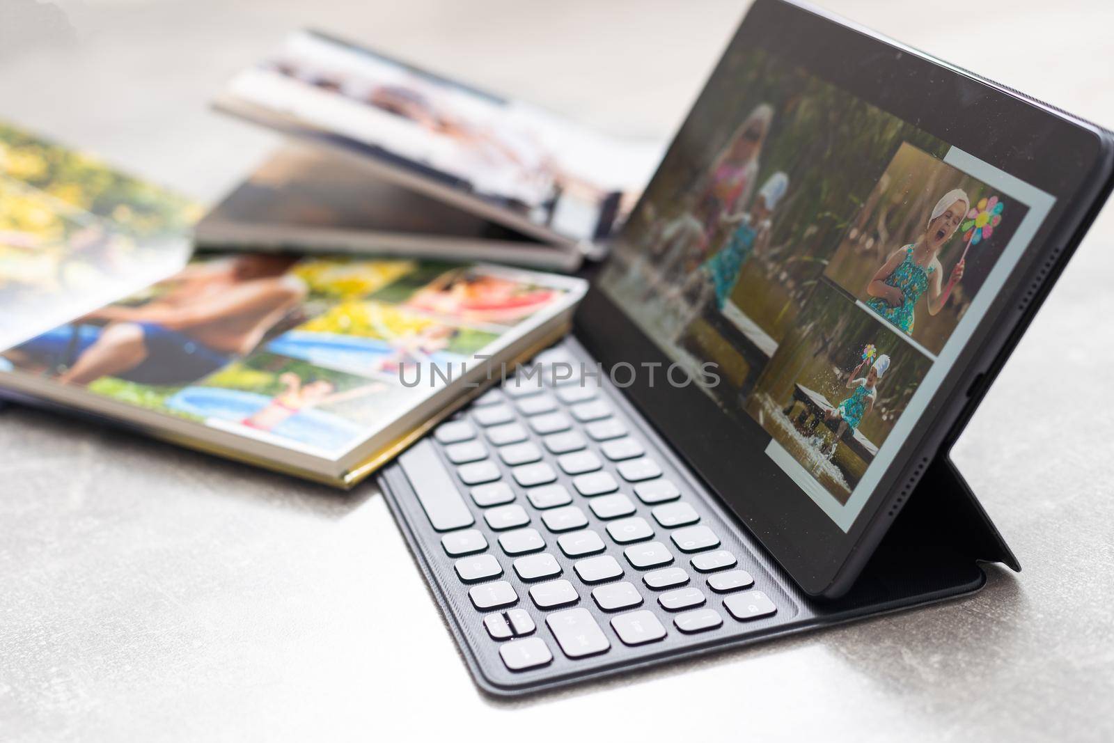 technology, age, memories and people concept. photobook album and tablet on the table.