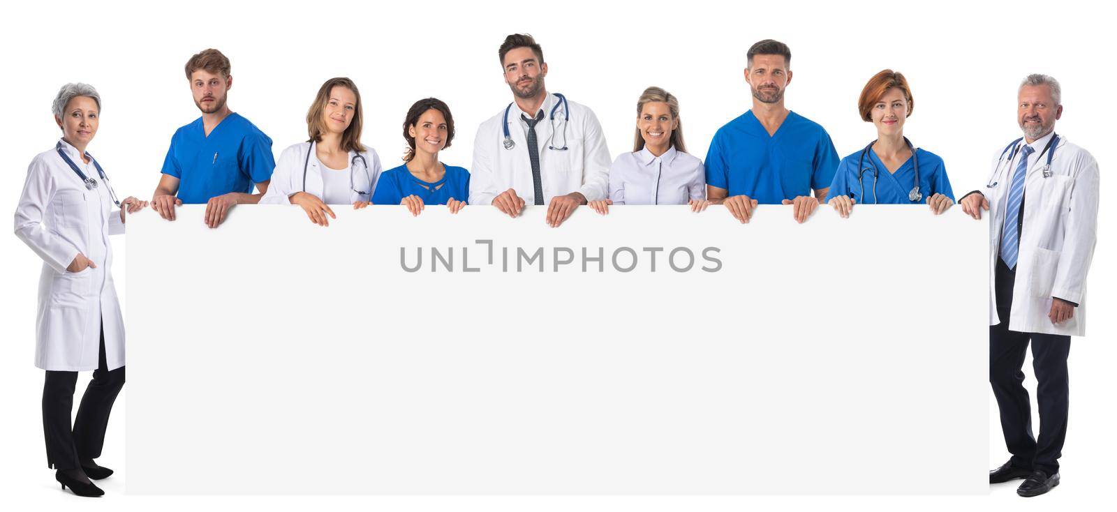 Group of doctors and nurses presenting empty banner. Isolated on white background, copy space for your text content