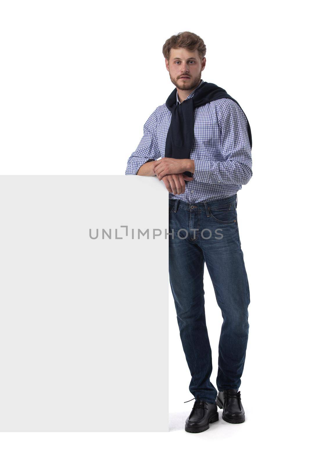 Full length portrait of young business man in casual clothes holding blank banner with copy space for your text isolated on white background