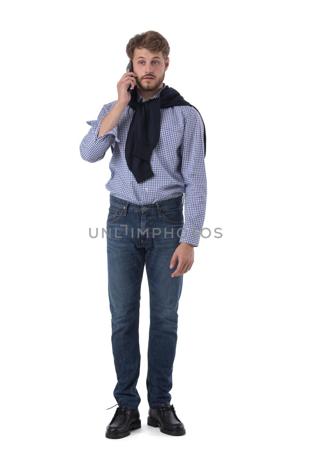 Full length portrait of young business man in casual clothes talking on the phone isolated on white background