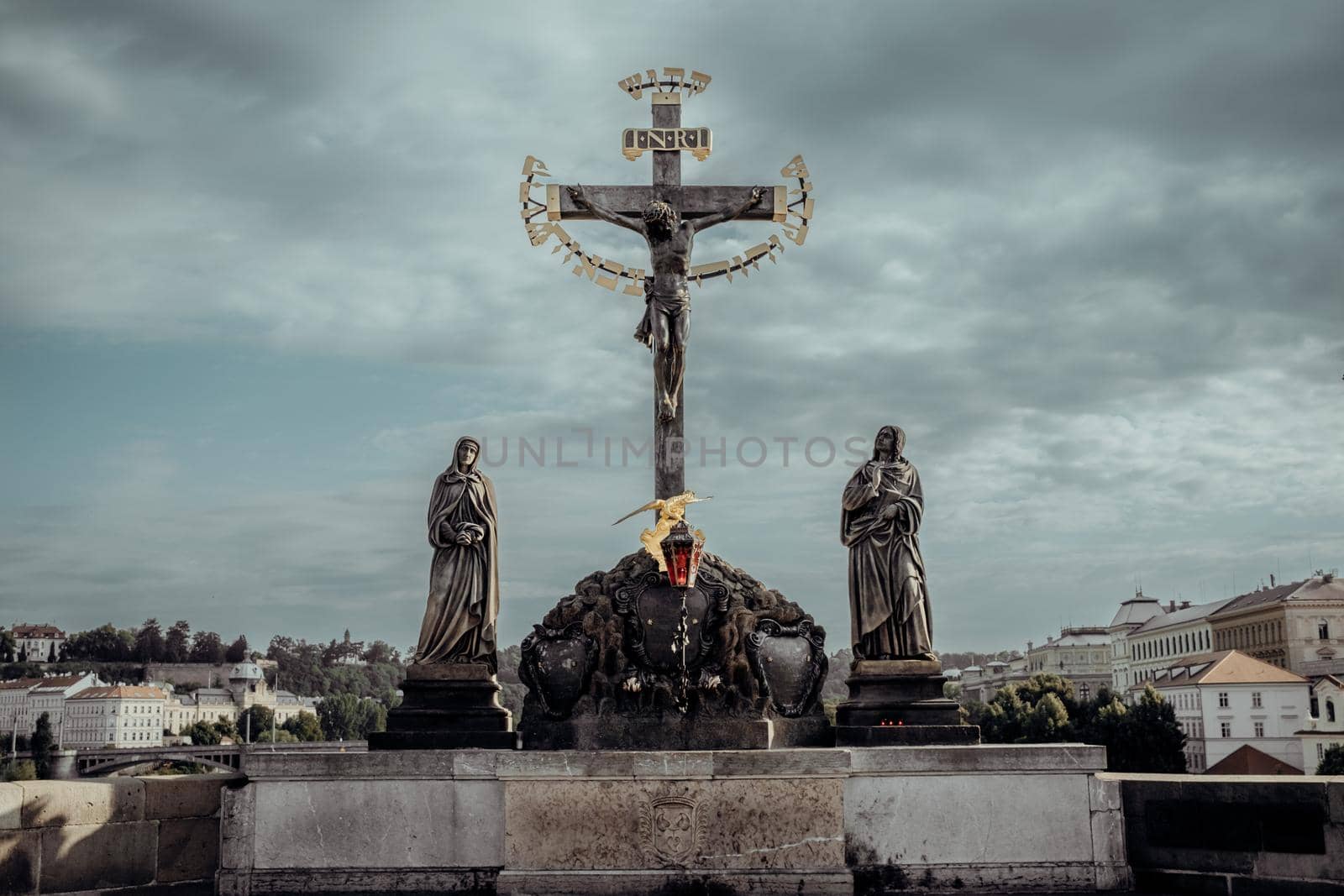 Significant monument - statue of crucified Christ on Charles bridge in Prague. 17th Century crucifixion statue with Hebrew lettering. Old town. by kristina_kokhanova