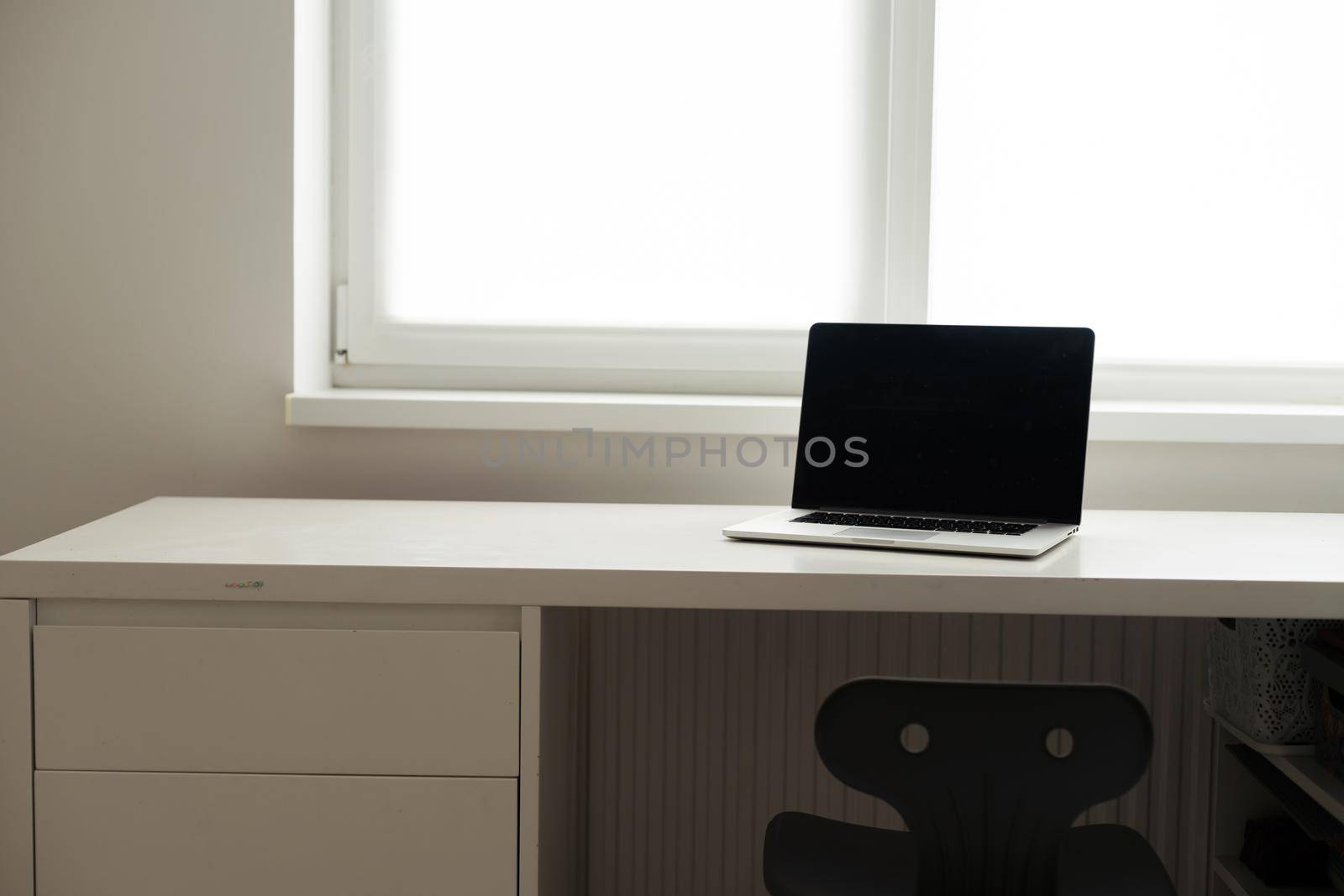 Horizontal photo of minimal workplace with computer laptop on white desk. by Andelov13
