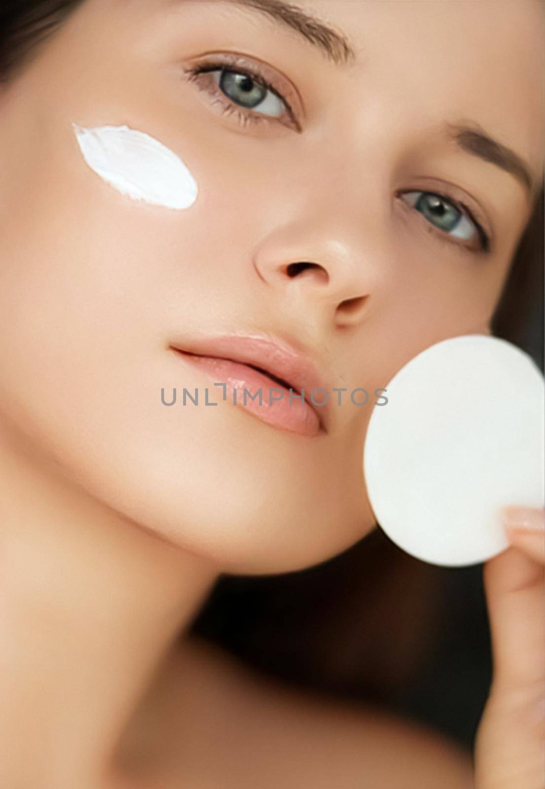 Beauty, face cream and skincare cosmetics model portrait, woman applying moisturiser, cleanser or make-up remover product with cotton pad, luxury facial and skin care routine by Anneleven