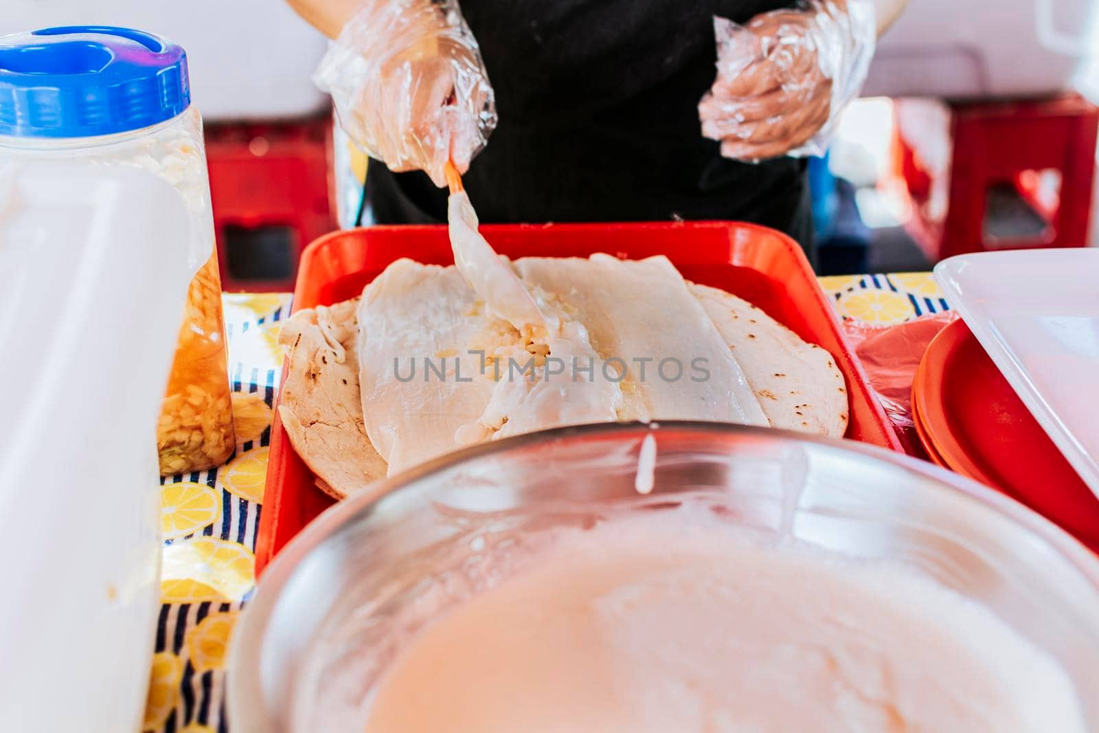 Nicaraguan quesillo, traditional Central American food quesillo. Hands making a Nicaraguan quesillo. Close up of hands making a traditional quesillo with pickled onion. by isaiphoto