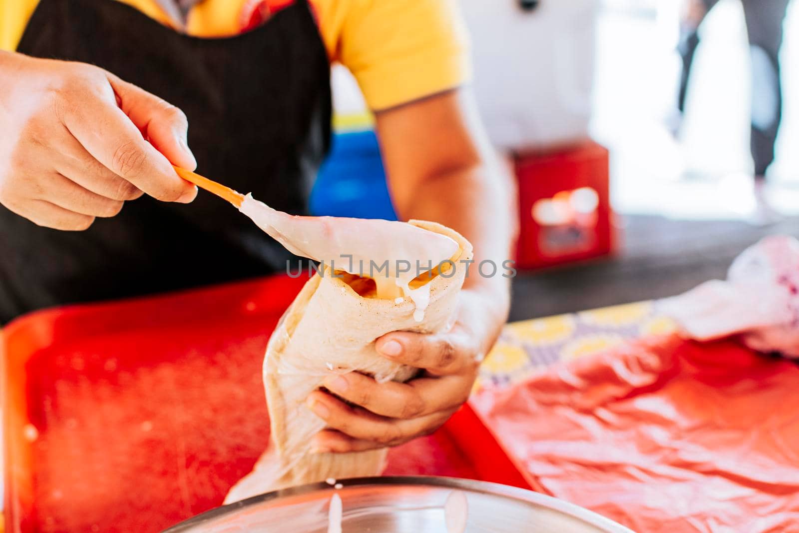 Close up of hands making a traditional quesillo with pickled onion. Hands making a delicious quesillo. Preparation of Nicaraguan quesillo, traditional Central American food quesillo